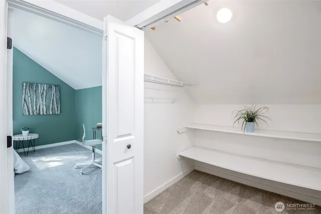 a spacious bedroom with a bed and a window