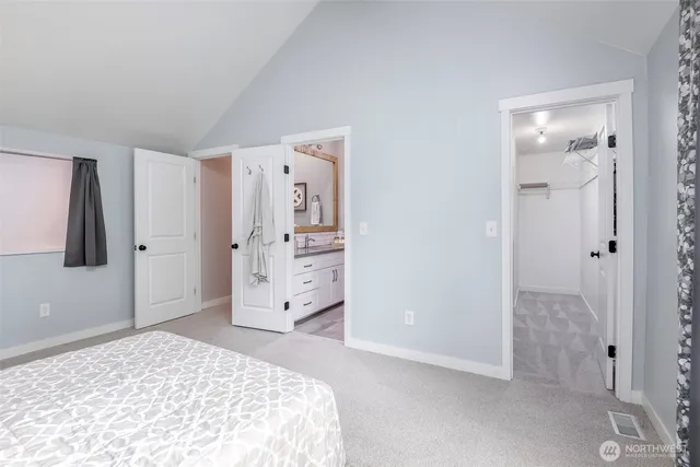 a bedroom with a bed and a couch