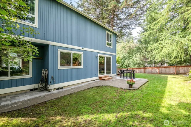 a view of a house with backyard porch and sitting area