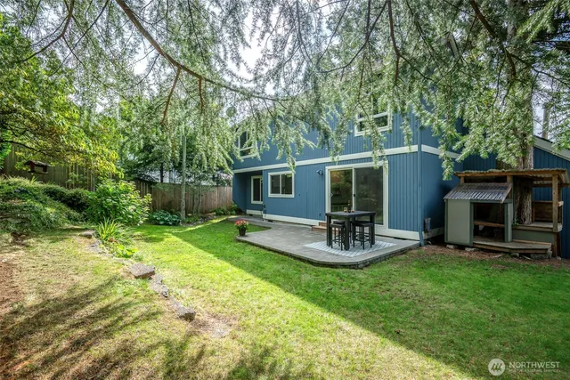 a view of yard with swimming pool and seating area