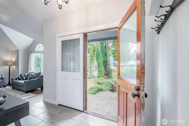a bathroom with a tub shower and mirror