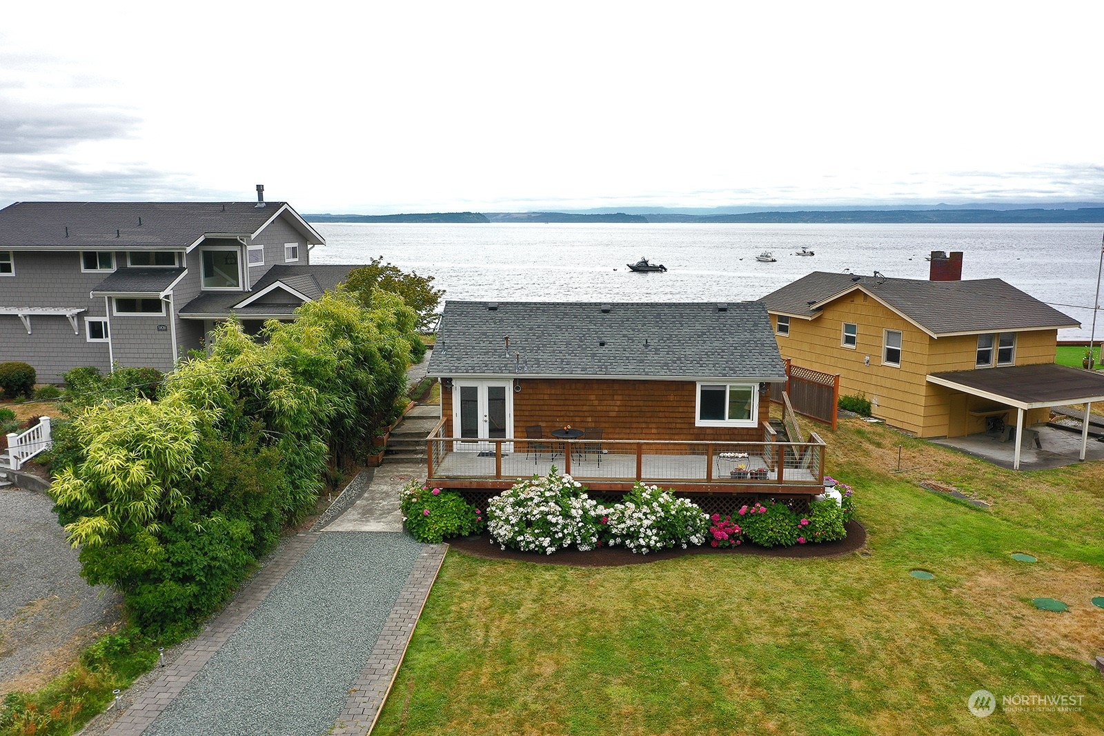 5818 Mutiny Bay Road Freeland, WA 98249 - Photo 3 of 40 an aerial view of a house with garden space and a car park