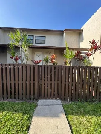 a front view of house with wooden fence