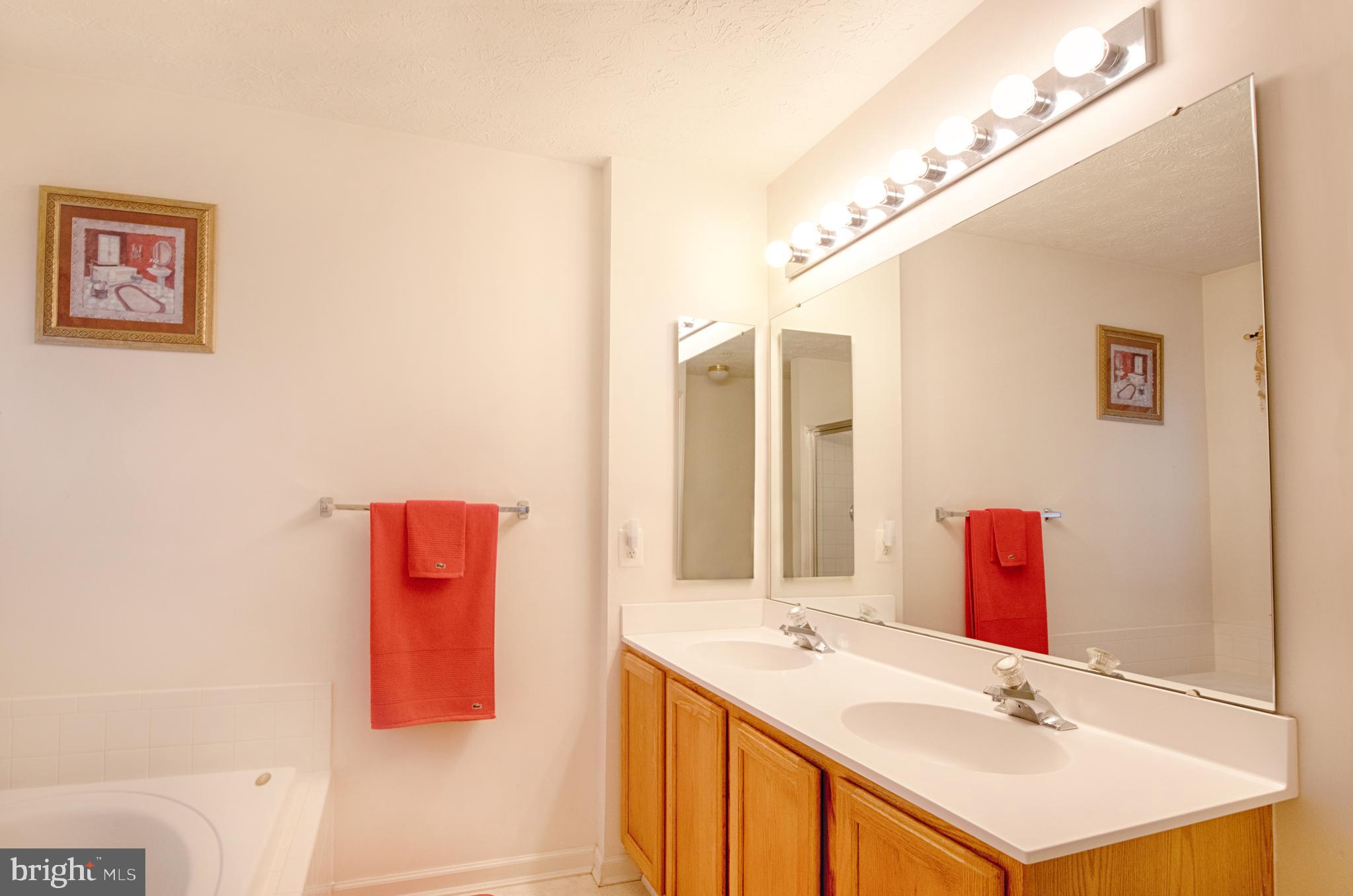 5034 Finsbury Road Baltimore, MD 21237 - Photo 12 of 23 Dual vanity w oak cabinetry in master bath