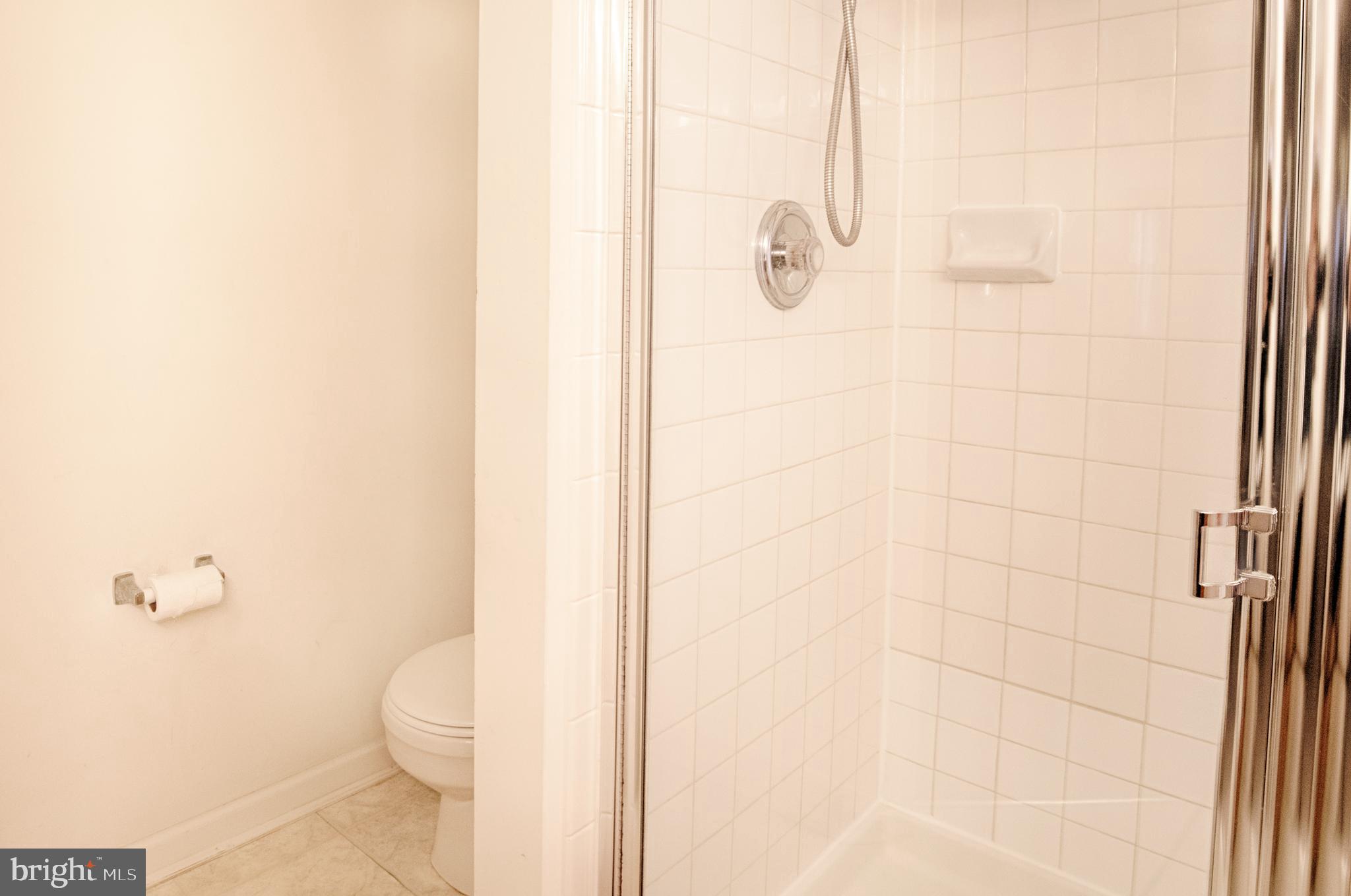 5034 Finsbury Road Baltimore, MD 21237 - Photo 13 of 23 Separate shower w white tile in master bath