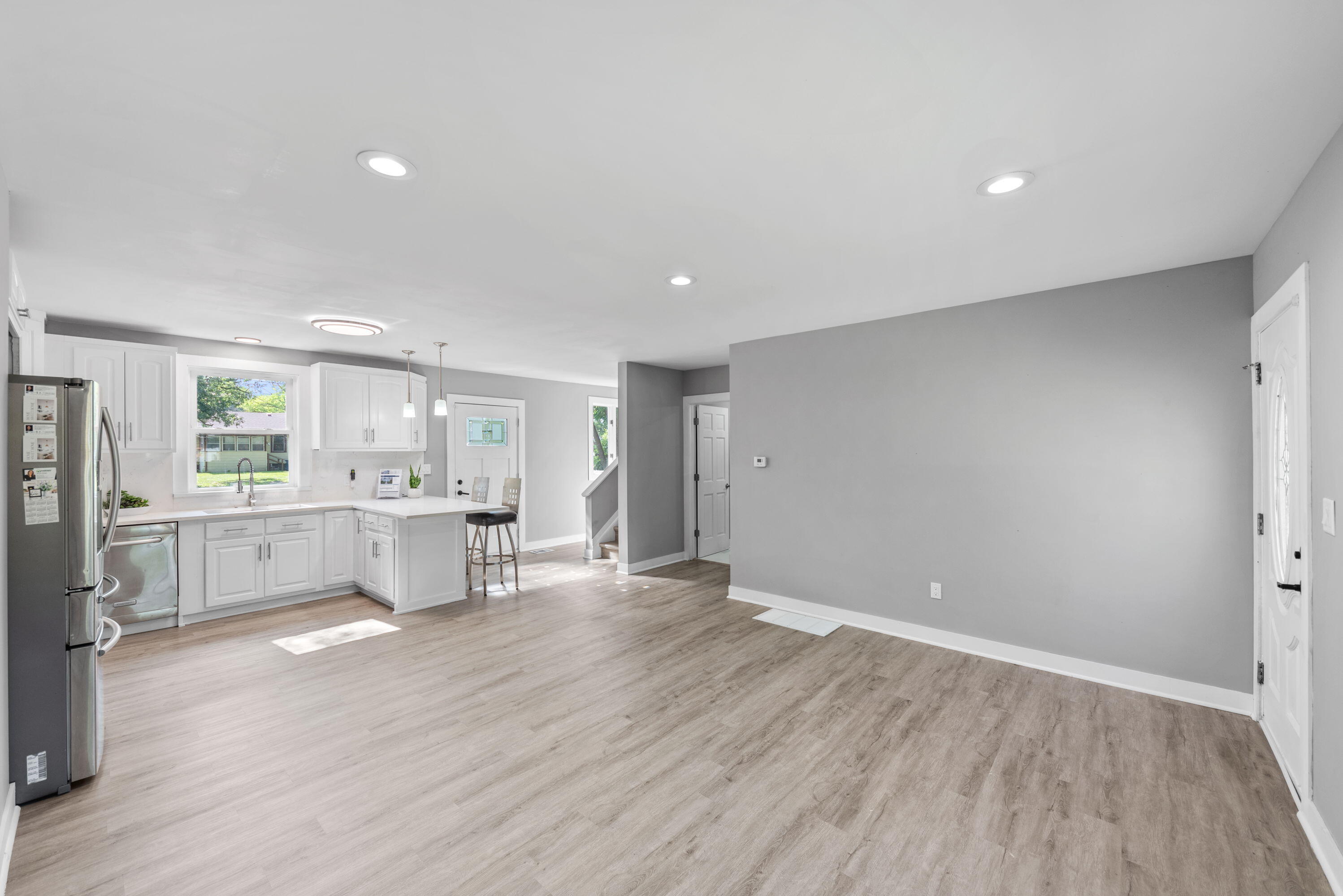 864 Ohio Street Gary, IN 46402 - Photo 3 of 27 a view of a kitchen with wooden floor and a window