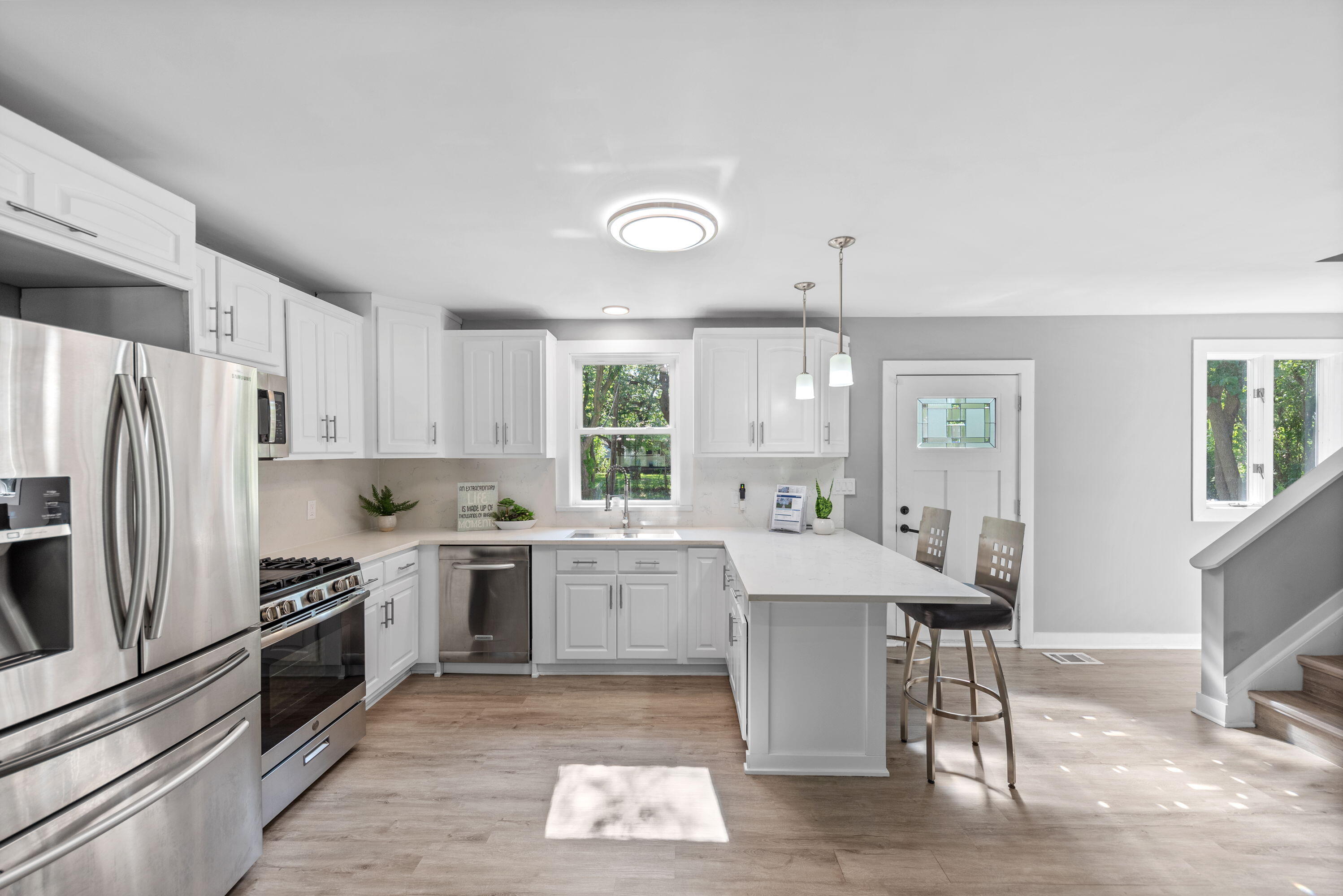 864 Ohio Street Gary, IN 46402 - Photo 5 of 27 a kitchen with a stove a sink dishwasher a refrigerator and cabinets with wooden floor