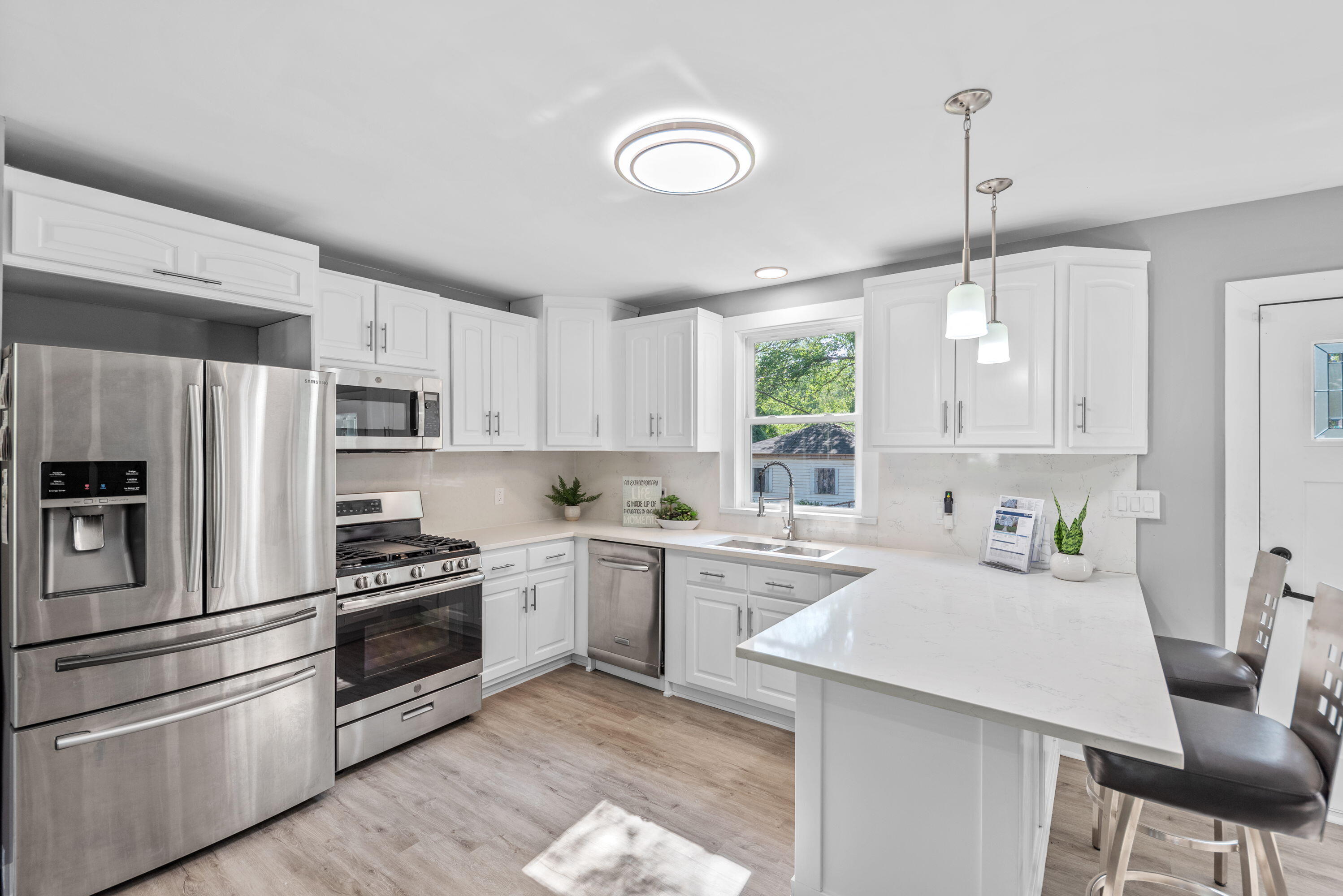 864 Ohio Street Gary, IN 46402 - Photo 6 of 27 a kitchen with a sink stainless steel appliances and window