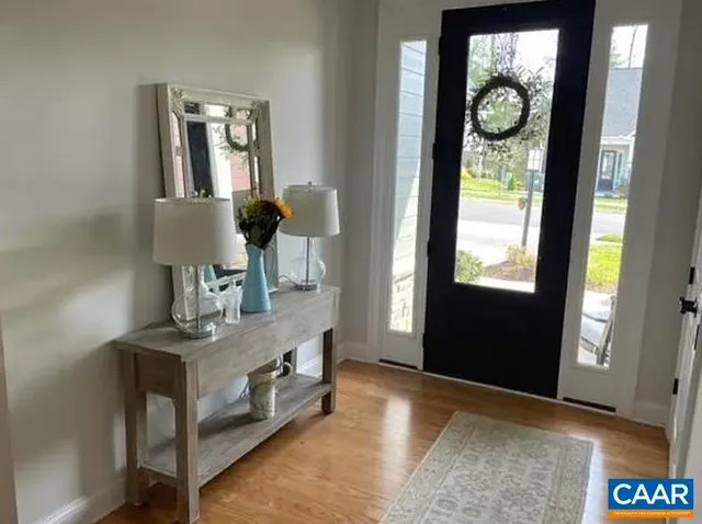 a room with table chairs and wooden floor