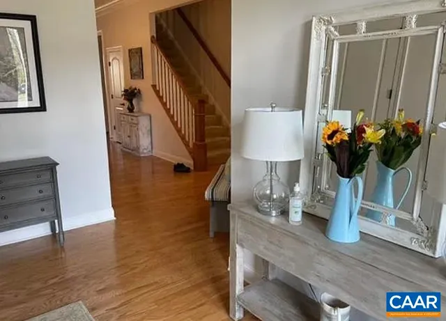 a kitchen with stainless steel appliances granite countertop a stove a refrigerator a microwave a dining table and chairs