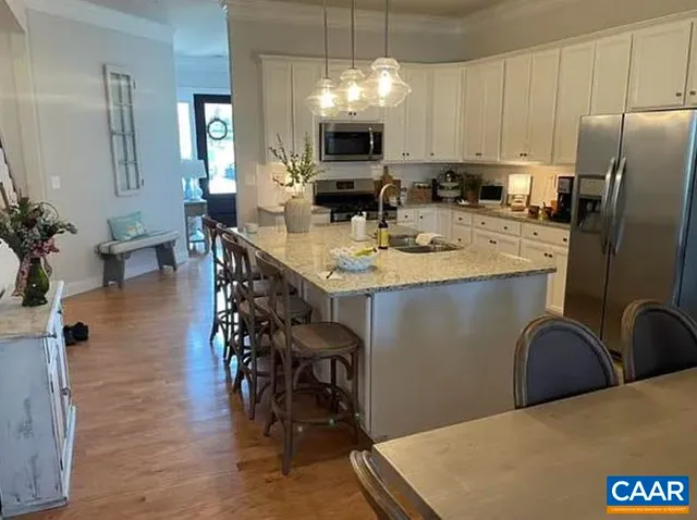 a kitchen with cabinets a sink and appliances