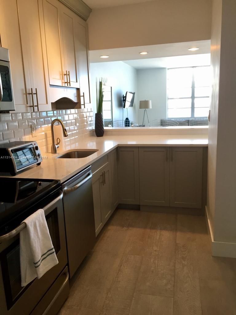 100 Lincoln Road, Unit 1225 Miami Beach, FL 33139 - Photo 3 of 10 a kitchen with granite countertop a sink stove and cabinets