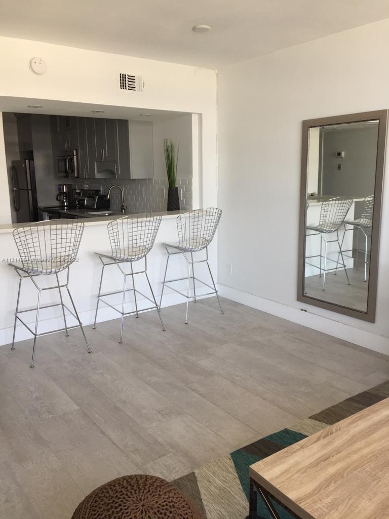 100 Lincoln Road, Unit 1225 Miami Beach, FL 33139 - Photo 5 of 10 a room with furniture and a wooden floor