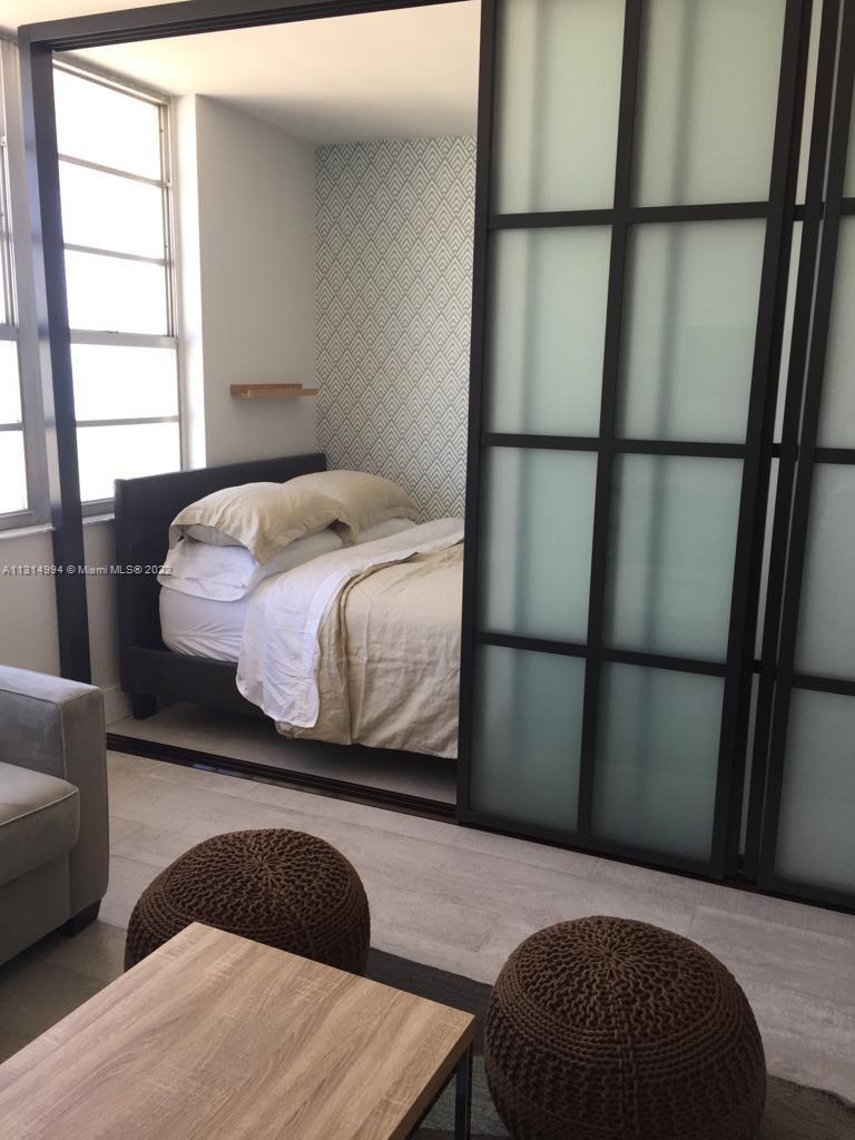 100 Lincoln Road, Unit 1225 Miami Beach, FL 33139 - Photo 6 of 10 a bedroom with a bed and a window