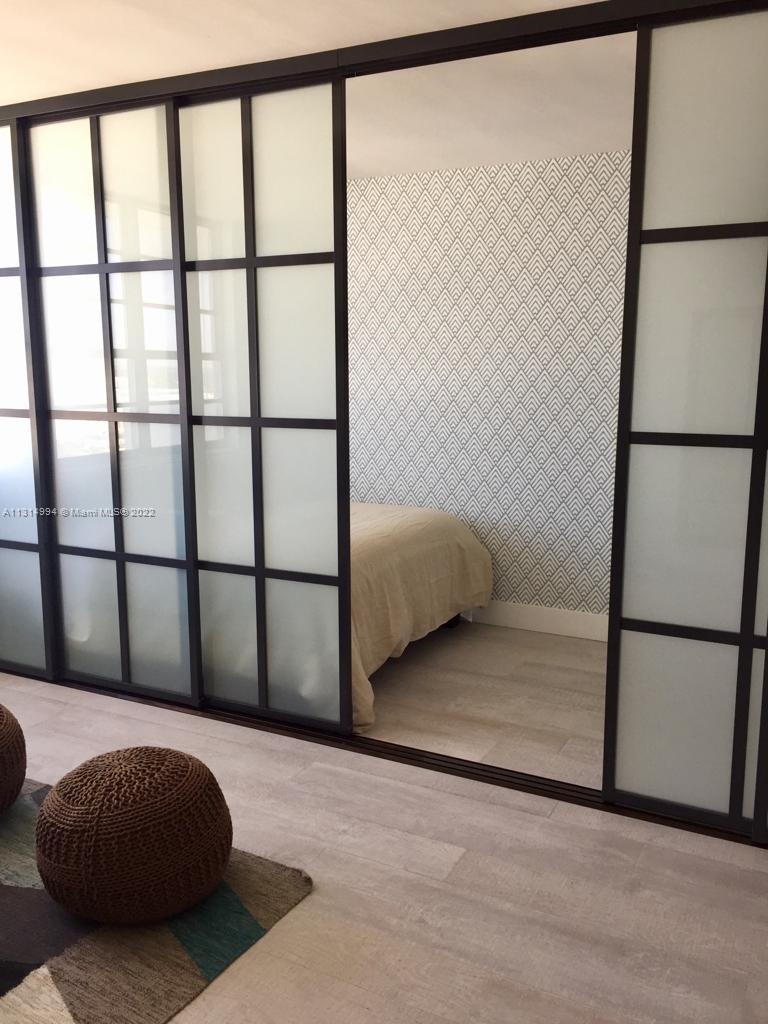 100 Lincoln Road, Unit 1225 Miami Beach, FL 33139 - Photo 7 of 10 a bedroom with a bed next to a window