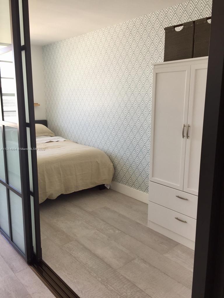 100 Lincoln Road, Unit 1225 Miami Beach, FL 33139 - Photo 8 of 10 a bedroom with a bed and a mirror