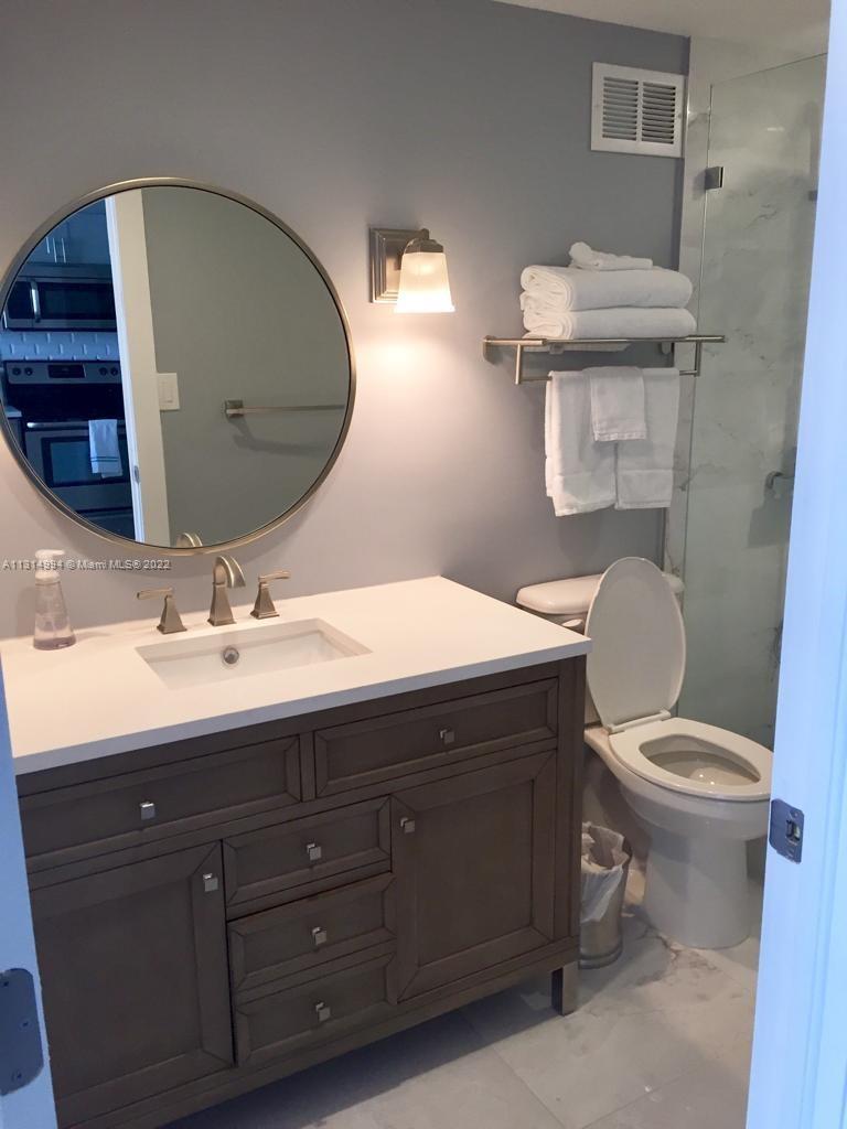 100 Lincoln Road, Unit 1225 Miami Beach, FL 33139 - Photo 10 of 10 a bathroom with a toilet sink and mirror