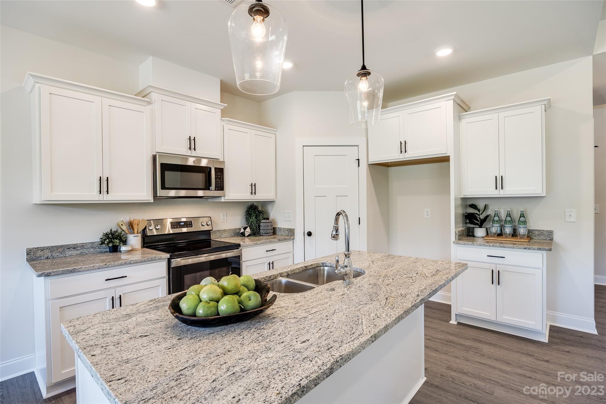 2209 State Rd S-46-1474, Unit 14 Clover, SC 29710 - Photo 11 of 33 a kitchen with stainless steel appliances granite countertop a sink a stove and a wooden floors