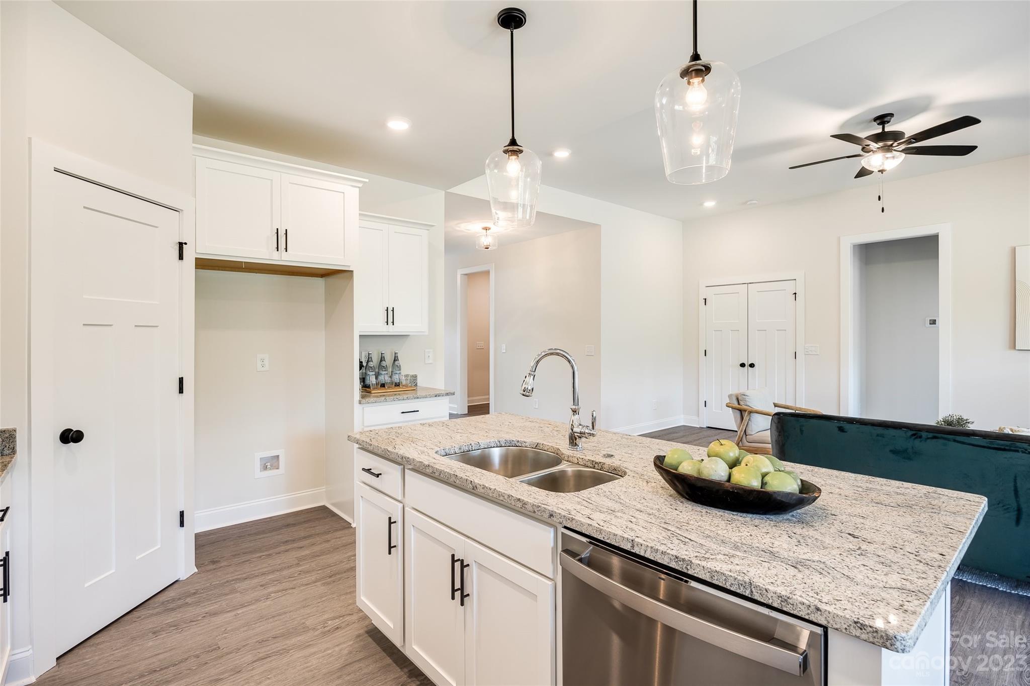 2209 State Rd S-46-1474, Unit 14 Clover, SC 29710 - Photo 12 of 33 a kitchen with a sink a chandelier and wooden floor