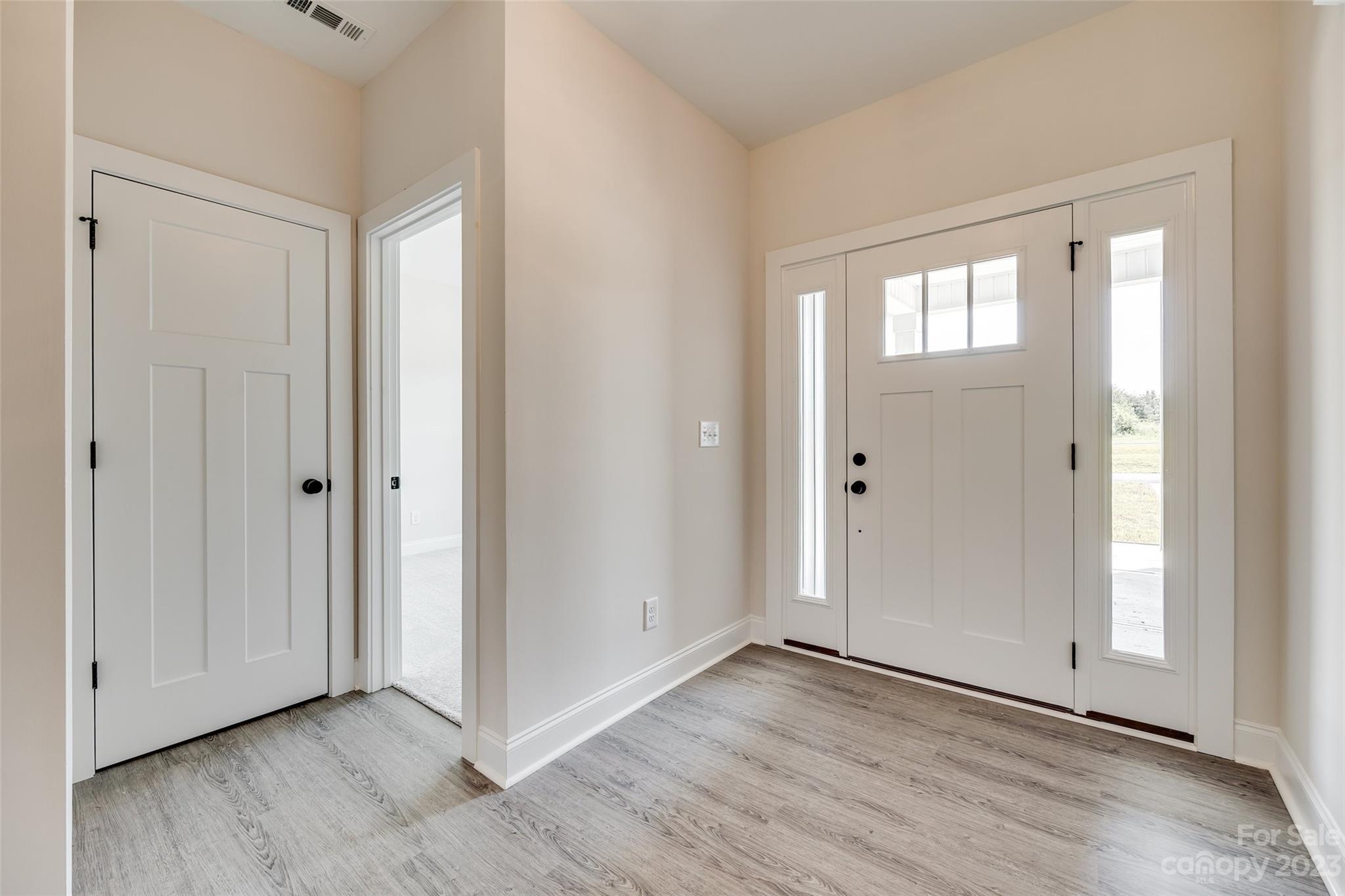 2209 State Rd S-46-1474, Unit 14 Clover, SC 29710 - Photo 3 of 33 a view of an empty room with wooden floor and a window