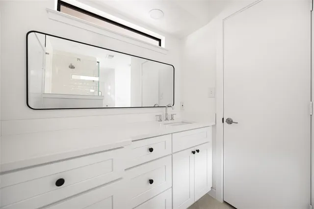 a bathroom with a sink and mirror