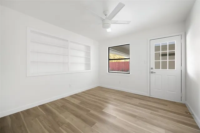 an empty room with windows and closet