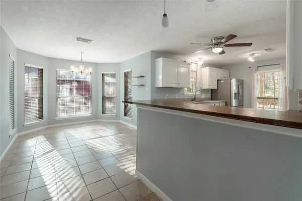 a large kitchen with kitchen island granite countertop a sink cabinets and stainless steel appliances