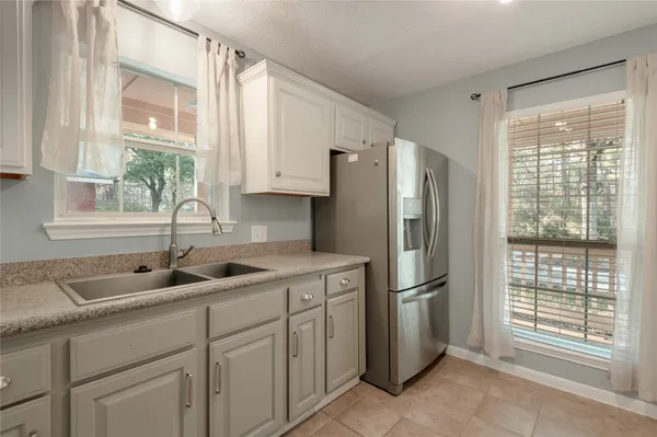 a kitchen with appliances cabinets and a sink