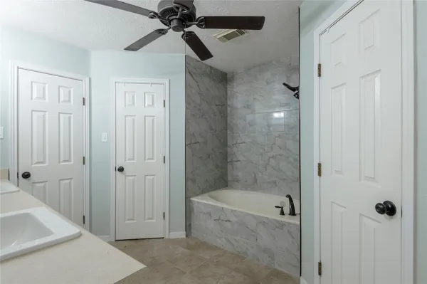 a bathroom with a bathtub and a shower