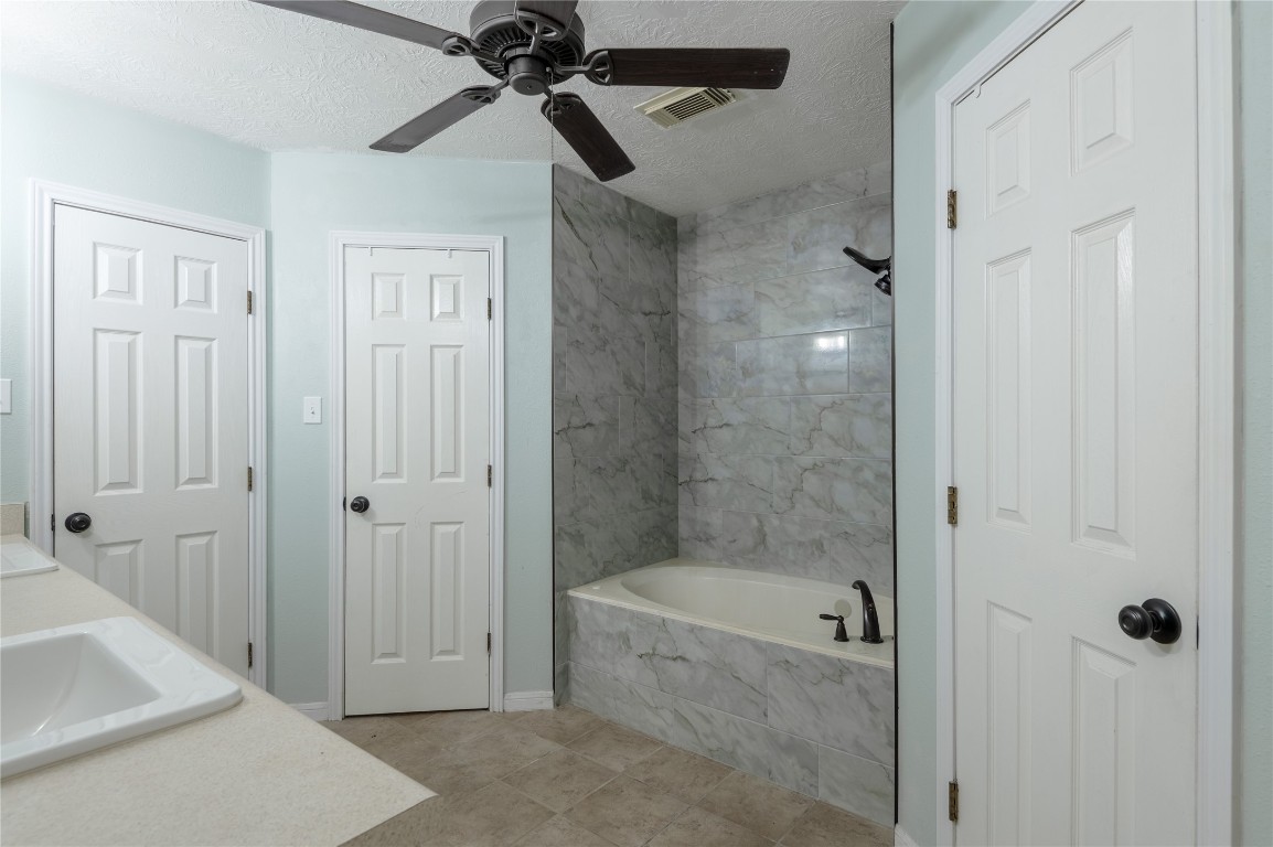 12 Quiet Wind Trinity, TX 75862 - Photo 24 of 48 The primary ensuite has double walk in closets, jetted tub/shower combo.