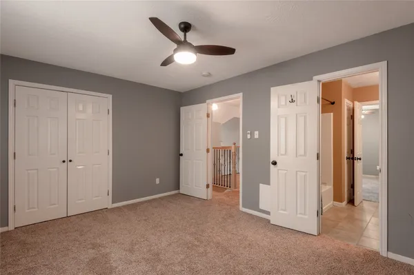 an empty room with closet and windows