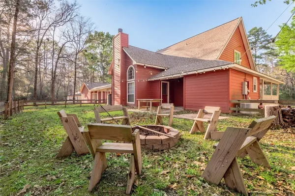 a view of backyard of house with outdoor seating