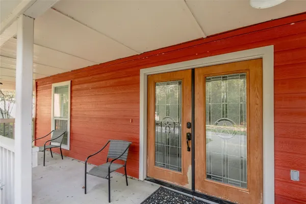 a balcony with chairs and table