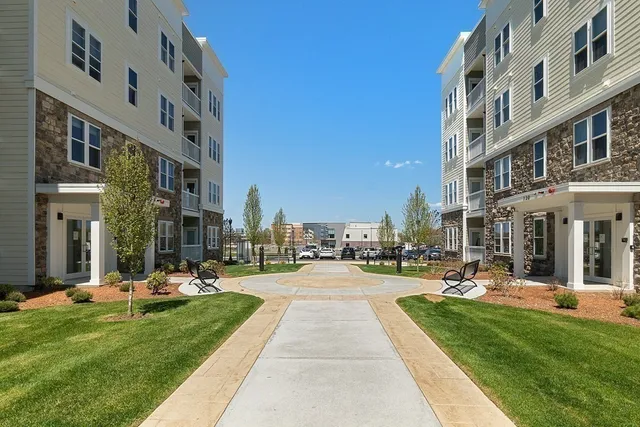 a row of pool with a yard and plants