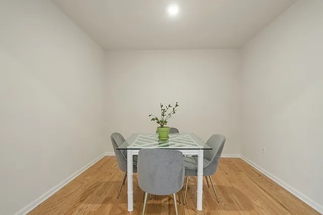 a dining room with furniture and wooden floor