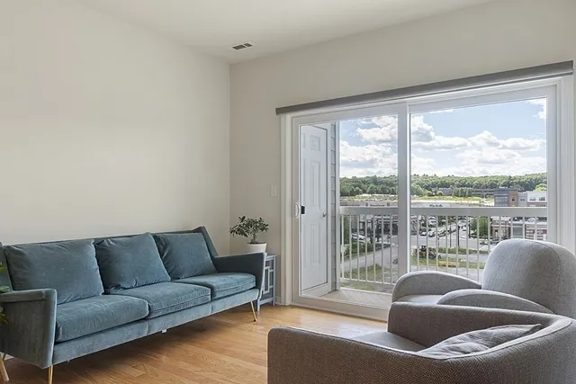 a living room with furniture and a large window