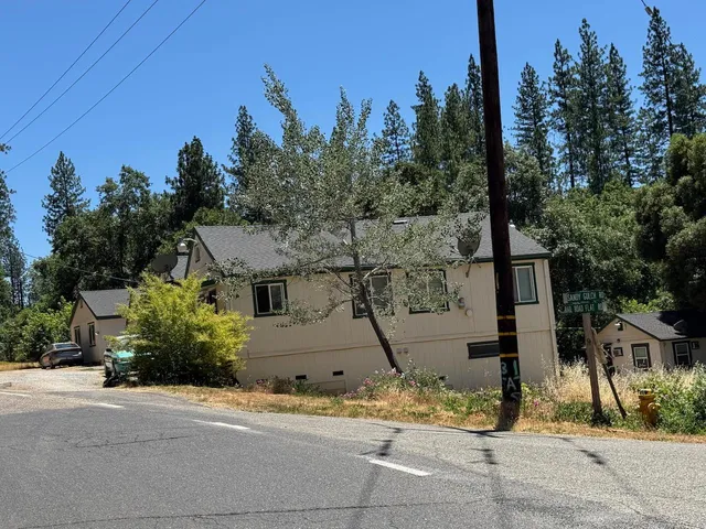 a front view of a house with trees