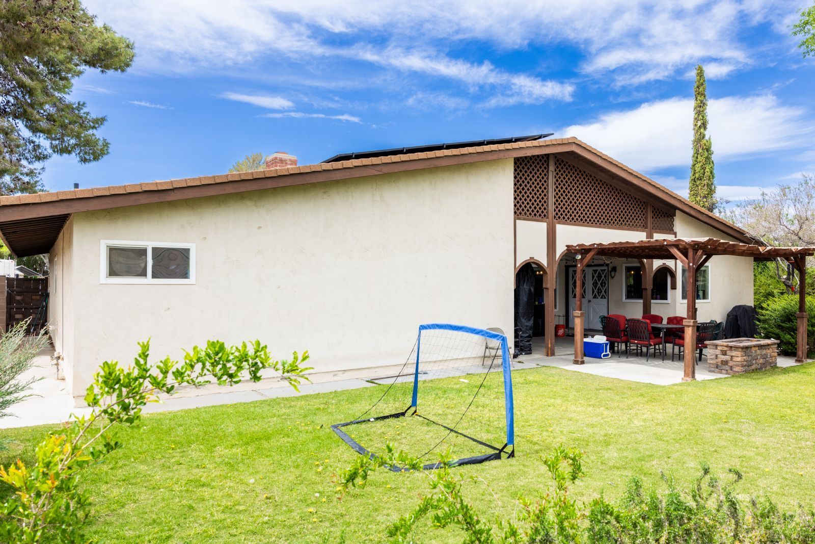 640 Peg Street Ridgecrest, CA 93555 - Photo 24 of 25 a backyard of a house with yard and outdoor seating