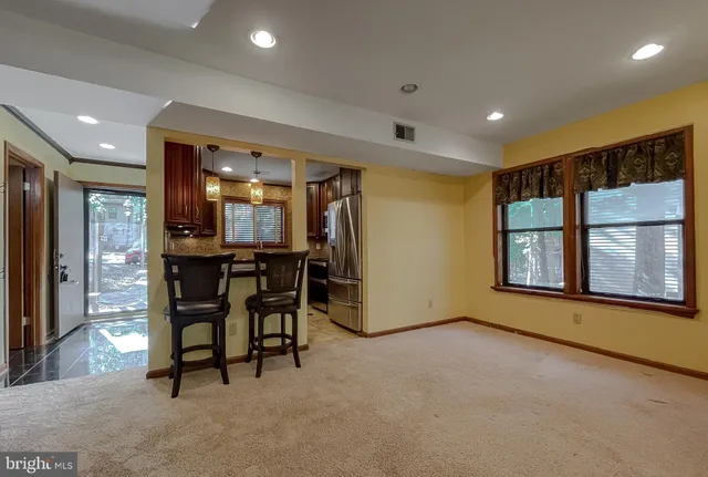 a view of an chairs and table in a room