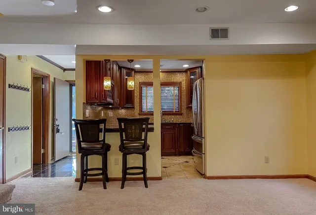 a view of a dining room with furniture and a chandelier