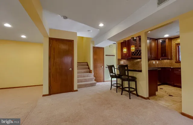 a view of kitchen with furniture and refrigerator