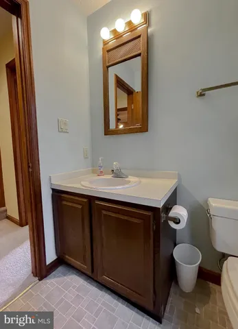 a bathroom with a toilet sink and mirror