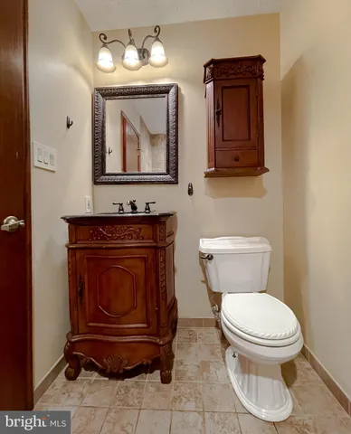 a bathroom with a toilet a sink and mirror