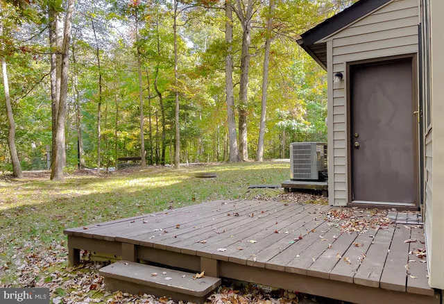 a wooden bench sitting in front of a house