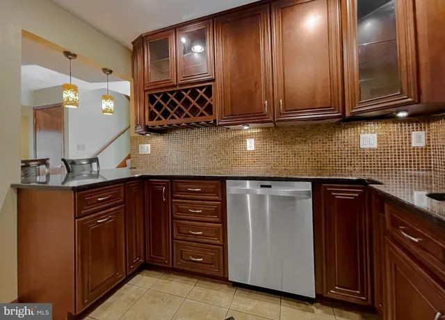 a kitchen with stainless steel appliances granite countertop wooden cabinets and a granite counter tops
