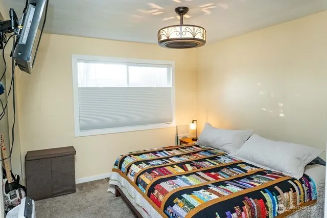 a bedroom with a bed and window