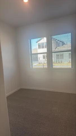 a aerial view of a brick house next to a yard