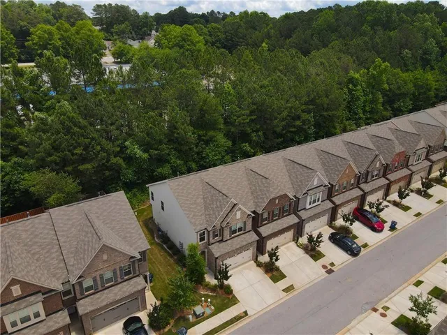 an aerial view of a house with yard