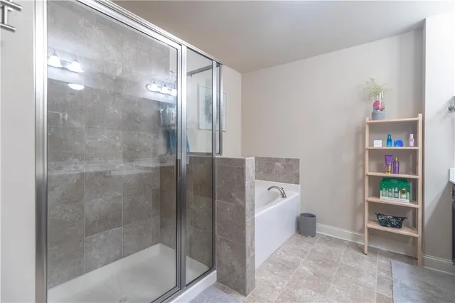 a bathroom with a bathtub and a shower