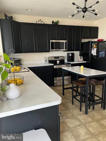 a kitchen with stainless steel appliances a stove a sink a microwave and cabinets